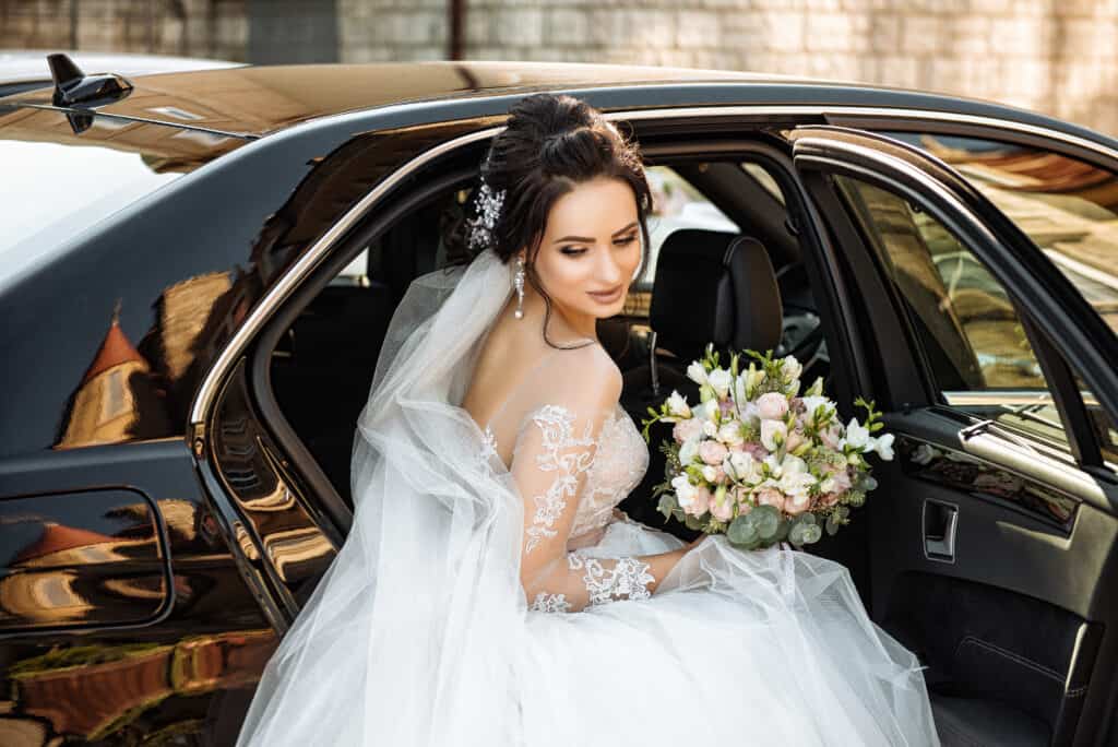 Bride out from a car on a wedding service rented on www.parisbyls.com luxury wedding chauffeur service